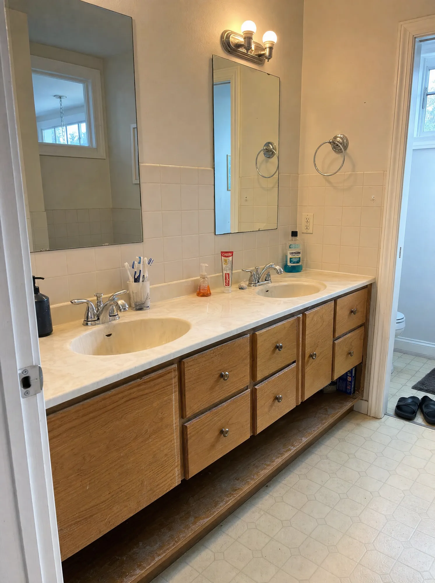 Before: Bathroom before and after a full remodel with a new wood double vanity, Rockville MD