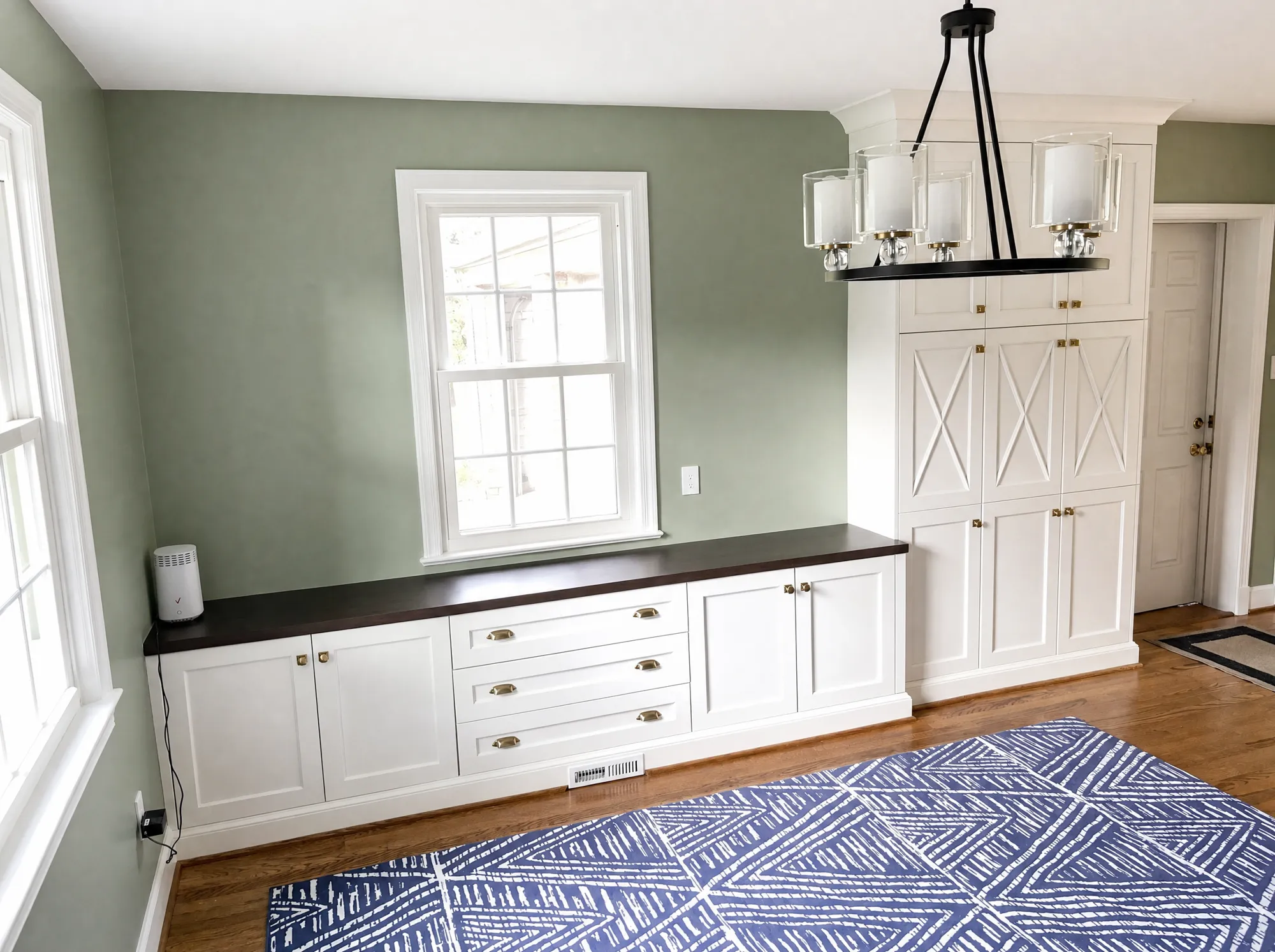 Custom white built-in buffet with dark top and X-panel pantry cabinet by Fogg Carpentry