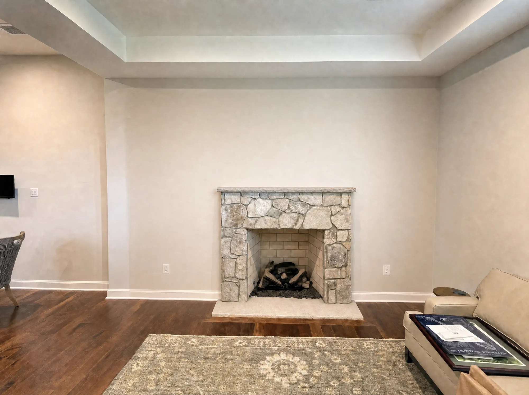 Before: Living room before and after custom built-ins around a stone fireplace, Rockville MD