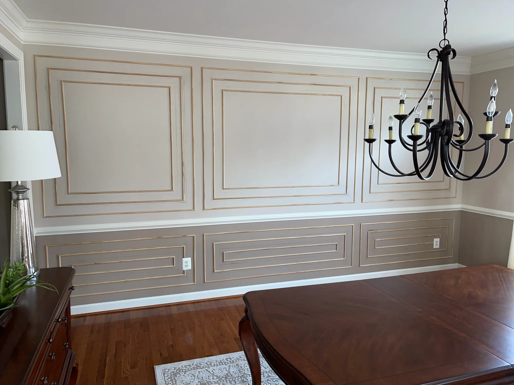 Dining room wall with layered picture-frame molding above and below a chair rail